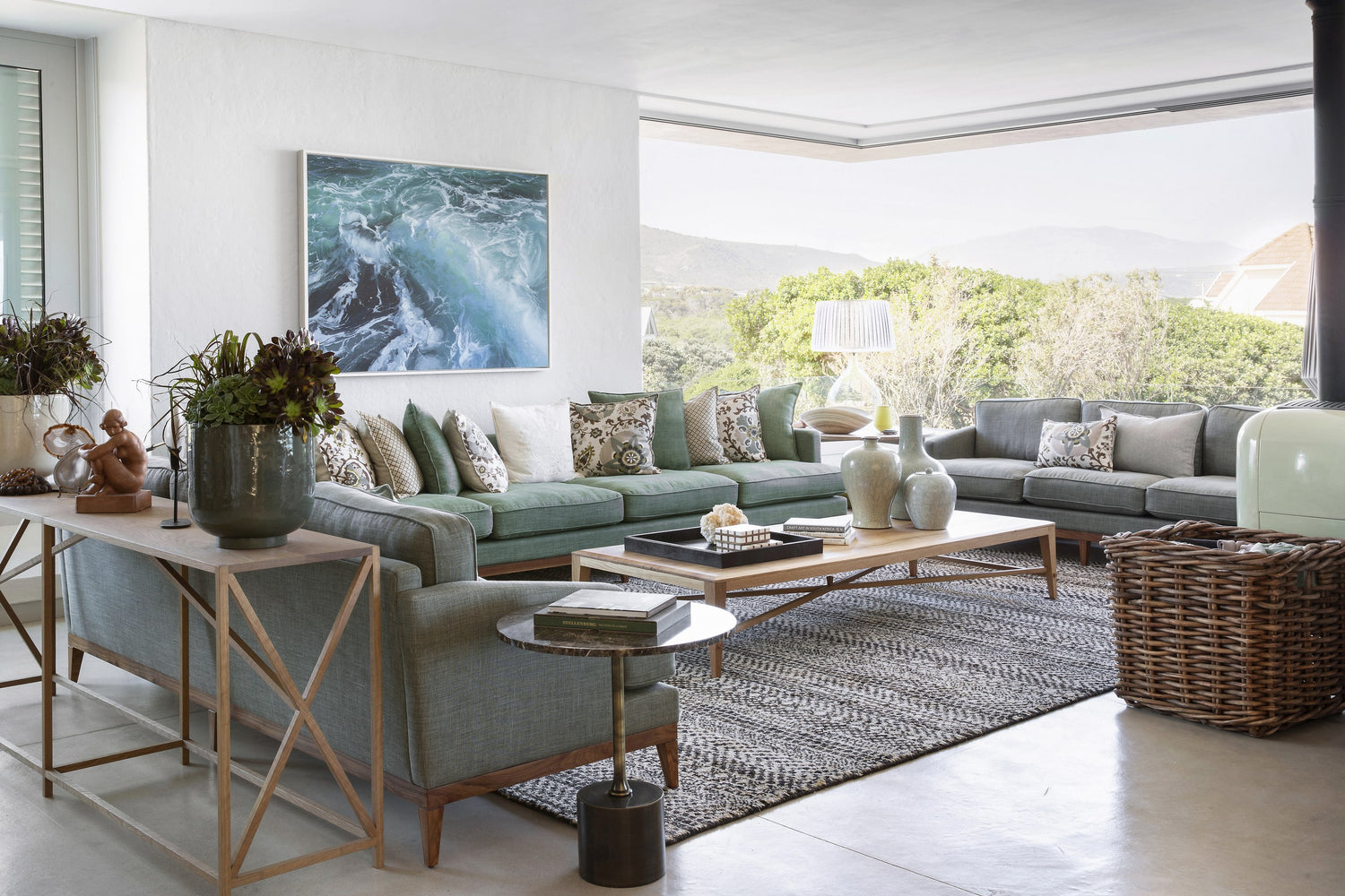 Modern living room with gray sectional sofa, coffee table, and decorative items.